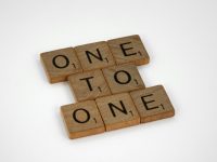 Image of Scrabble tiles arranged to form the phrase "One to One" on a white background.